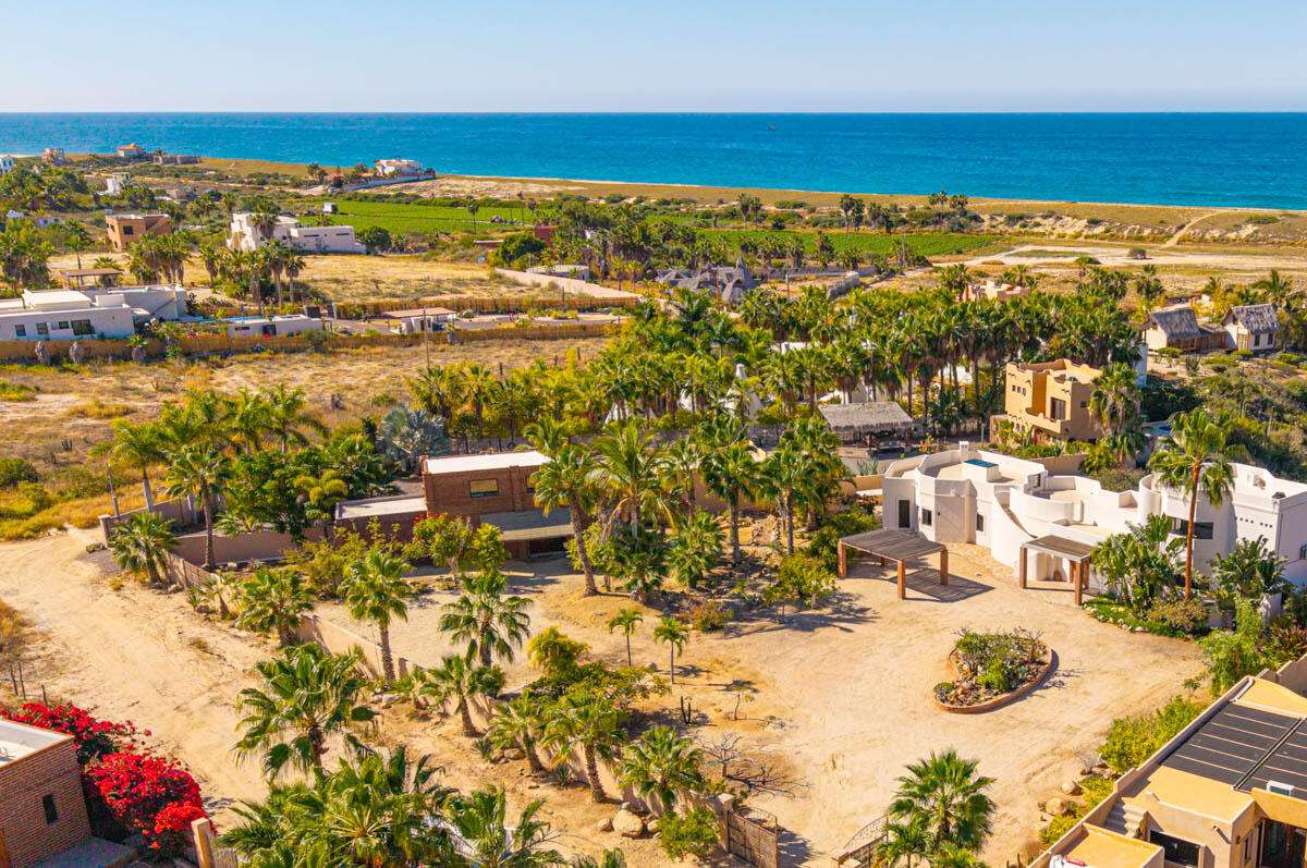 Todos Santos Pescadero Classic surf casita in El Pescadero — steps from San Pedrito. Just one row back from the beach in one of the most peaceful coastal enclaves of El Pescadero, this classic Mexican surf casita sits on an oversized ½+ acre lot surrounded by palms, mature gardens, and ocean air. A walled and gated sanctuary with CFE power, active Ejido water, cistern and pump, and established fideicomiso this is the rare combination everyone waits for here. From the rustic loft bedroom and second floor, watch whales pass, follow every winter sunset, and fall asleep to Pacific surf. The existing home comes with completed architectural remodeling plans for a two-story, two-bedroom home. The existing home has a loft living area under the palapa roof, two baths, and a garage. This land is ideal for those who want to grow food, build a food forest, practice permaculture, or simply live seasonally outdoors. This corner of San Pedrito has become a small, quiet, like-minded community with slow mornings, surf walks, starry nights, supportive neighbors, and true Baja time.Walk to the world-class San Pedrito surf break. Ride a bike to farm stands, coffee, mezcal bars, and small eco-tourism operations. It is still the old Baja feeling but with the infrastructure that makes living easy.A rare chance to own a spacious coastal property in one of Baja's most effortlessly soulful places, an opportunity for people to build a different life. for sale