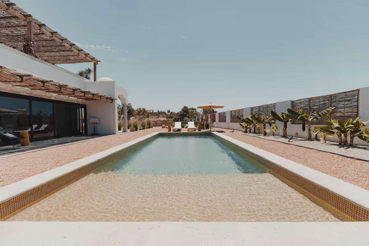 Todos Santos Todos Santos-General Villa Serena is a contemporary residence in Todos Santos designed for both private enjoyment and income-producing vacation rental operation. Set on a 995 m² lot, the property offers 289 m² of total construction, including 180 m² of air-conditioned living space and 109.60 m² of decks and terraces.The home features three bedrooms, three full bathrooms, two half bathrooms, a dedicated office, open-concept living and dining areas, a fully equipped kitchen, private swimming pool, sauna, outdoor fireplace and parking for up to four vehicles. Currently operating as a luxury vacation rental with an established Airbnb presence and Superhost status, Villa Serena offers a compelling opportunity for buyers seeking a high-quality second home or a turnkey investment asset in one of Baja for sale