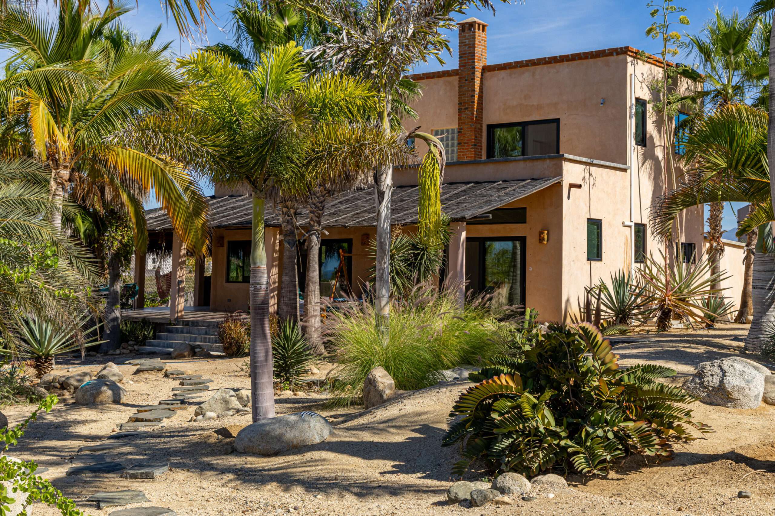 Todos Santos Las Tunas Immerse yourself in the vibrant colors of Mexico. Impeccably maintained two-bedroom, two-bath home with open floorplan is perfect for entertaining. Enter the home through the first of two private courtyards to discover a splashing fountain and a hand carved front door with wrought iron accents Polished Saltillo tile floors throughout lead from the spacious kitchen into the first of two living areas, enhanced with an intimate wood burning fireplace and casual equipal dining table and chairs. From there step into the spacious great room with wrap around windows highlighting sparkling ocean for sale