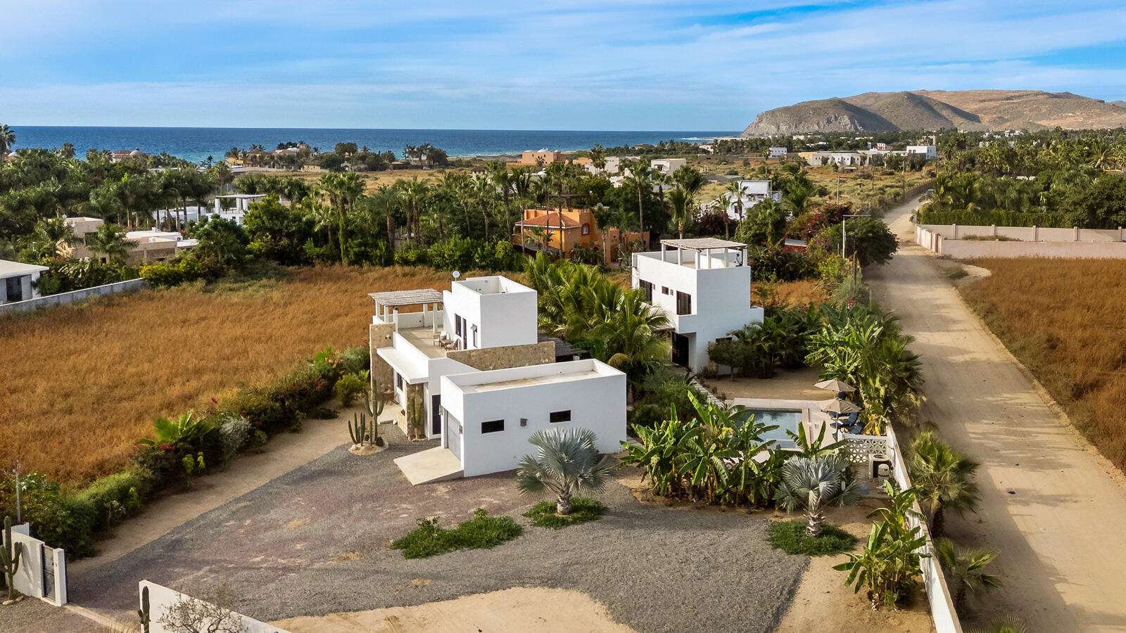 Todos Santos Pescadero Stunning Turnkey Property Featuring Two Finished & Fully Furnished Homes, Steps from the BeachWelcome to this exceptional coastal retreat, offering two fully furnished and beautifully finished homes on one expansive property. Located just a 5-minute walk from the beach, this compound-style oasis provides privacy, luxury, and flexibility for multigenerational living, rental income, or hosting guests in complete comfort. Property Highlights* Two completed and fully furnished homes (2024)* 4 Bedrooms, 4 Full Baths & 2 Half Baths with custom finishes* Heated custom-built pool and hot tub (4x8 meters) with tiled patio and walkways* Four inviting pergolas offering shaded outdoor living spaces* Garage with power door + powered exterior entry gate* 6-ft concrete privacy wall on two sides and a lush living wall of mature bougainvillea on the thirdInterior Features* Custom wood cabinetry and closets throughout both homes* Finished concrete countertops for a modern coastal aesthetic* Newer stainless-steel appliances: gas oven, hood, fridge, dishwasher* LG stackable washer/dryers in both homes* LG split air conditioners, newer models, for efficient cooling* Water filtration system for both homes* Custom-built bathtub with artisanal detail* Furnishings include modern outdoor dining and living sets, interior décor, and turnkey essentialsOutdoor & Garden Features* Heated pool with custom-designed equipment enclosure* Multiple tiled patios and walkways for seamless indoor-outdoor living* Extensive, irrigated tropical garden with bananas, lime trees, mango, avocado, several varieties of palm, torotes, cactus, and birds of paradise* Four pergolas offering serene spaces for lounging, dining, or entertainingAdditional Features:* Custom stone exterior accents* Two fully independent homes ideal for guests, rentals, or family* Quiet, private environment yet just minutes from the sandThis property offers a rare combination of craftsmanship, mature landscaping, thoughtful design, and coastal proximity. Completely turnkey and fully furnished, it is ready for you to move in and begin enjoying life in Baja Sur from day one. for sale