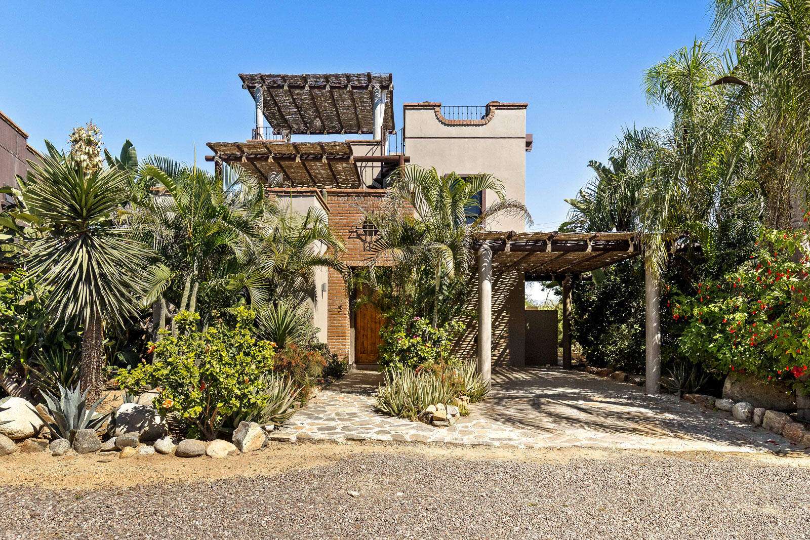 Todos Santos Las Tunas Immerse yourself in the vibrant colors of Mexico. Impeccably maintained two-bedroom, two-bath home with open floorplan is perfect for entertaining. Enter the home through the first of two private courtyards to discover a splashing fountain and a hand carved front door with wrought iron accents Polished Saltillo tile floors throughout lead from the spacious kitchen into the first of two living areas, enhanced with an intimate wood burning fireplace and casual equipal dining table and chairs. From there step into the spacious great room with wrap around windows highlighting sparkling ocean for sale