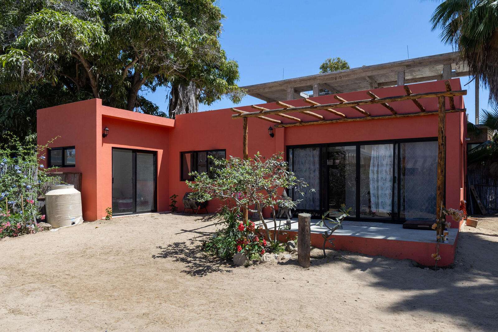 Todos Santos Pescadero Welcome to Hacienda Maracuyá, a true gardener's paradise tucked within the sought-after Huerta Hermosa community in Pescadero. Set on a coveted double lot, this unique property offers a rare blend of privacy, lush tropical living, and the relaxed Baja lifestyle--without the premium price tag. Surrounded by an established mango grove that creates a naturally cooler microclimate, the property feels like a secluded oasis. Mature, producing trees and vines--including grapefruit, lime, lemon, orange, naranjita, coconut palms, lychee, rambutan, papaya, and passionfruit--wrap the grounds in greenery, creating a vibrant, living landscape.The existing ranch-style home features 2 bedrooms and 1 bathroom with an open-concept kitchen and living area, offering a clean canvas ready for your personal design and finishing touches. The unfinished rooftop space provides the opportunity to create a spacious primary suite, complete with room for a private patio, outdoor gym, or additional lounge area--designed entirely to your vision.Outdoor living is at the heart of this property. A charming palapa with a swinging daybed invites long, lazy afternoons, while a larger palapa with French doors, breezy patios, a kitchenette, and an outdoor shower and bath with on-demand hot water creates the perfect setting for entertaining or unwinding in nature. This flexible setup also lends itself beautifully to short-term rental potential, offering a private, turnkey guest experience that could generate additional income while maintaining the property's relaxed, tropical charm.The backyard is a true sanctuary... lush, private, and full of potential--ready for the next owner to bring their creativity to life and elevate it into a one-of-a-kind outdoor retreat.As part of the Huerta Hermosa community, residents enjoy access to a large lap pool, multiple community gardens producing fresh fruits and vegetables, and the renowned Crudo restaurant. The neighborhood offers a unique mix of local residents and seasonal expats, fostering a welcoming, laid-back atmosphere centered around connection, sustainability, and outdoor living.Located just a short ATV ride from some of Baja's best surf breaks and minutes from the energy of Cerritos, this property strikes the perfect balance; close to everything, yet far enough removed to maintain peace, privacy, and tranquility.If you've been searching for a property with soul, space to create, and true Baja charm, Hacienda Maracuyá is an opportunity not to be missed. for sale