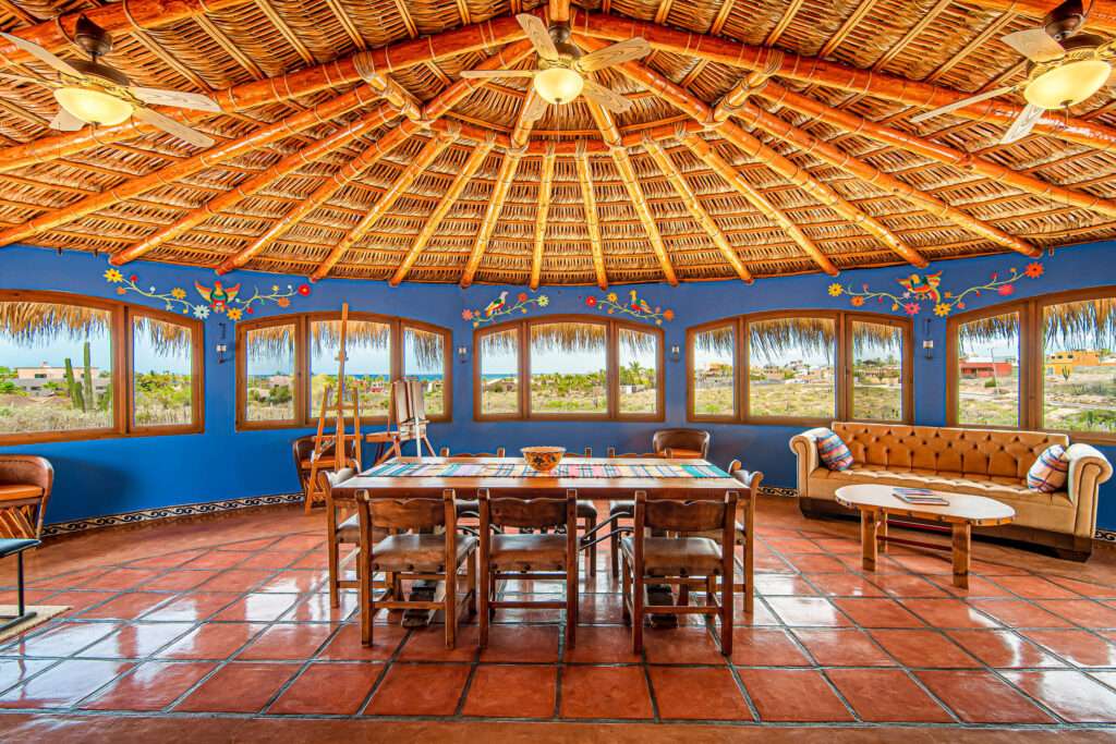 Todos Santos Las Tunas Immerse yourself in the vibrant colors of Mexico. Impeccably maintained two-bedroom, two-bath home with open floorplan is perfect for entertaining. Enter the home through the first of two private courtyards to discover a splashing fountain and a hand carved front door with wrought iron accents Polished Saltillo tile floors throughout lead from the spacious kitchen into the first of two living areas, enhanced with an intimate wood burning fireplace and casual equipal dining table and chairs. From there step into the spacious great room with wrap around windows highlighting sparkling ocean – Casa de Colores, Pacific, Pacific, BS